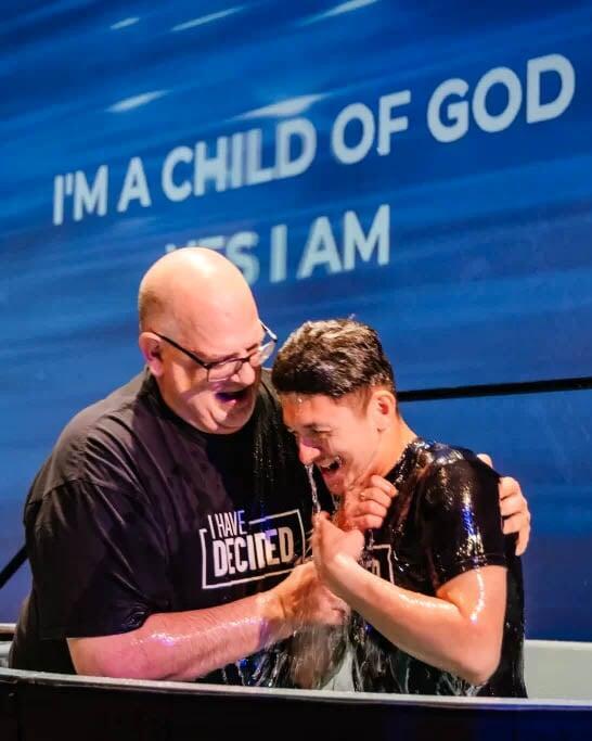 Pastor Baptizing church member with joy